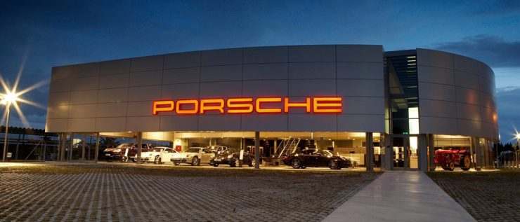 Porsche dealership at night.