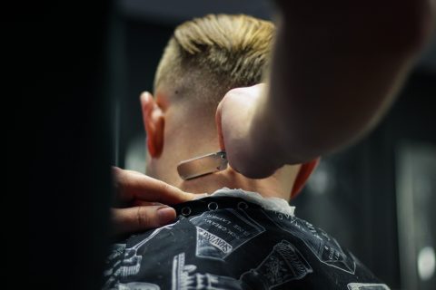 blonde hair loss person trimming man's hair