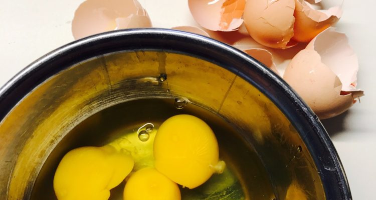 Detox Diet cracked eggs beside round blue bowl