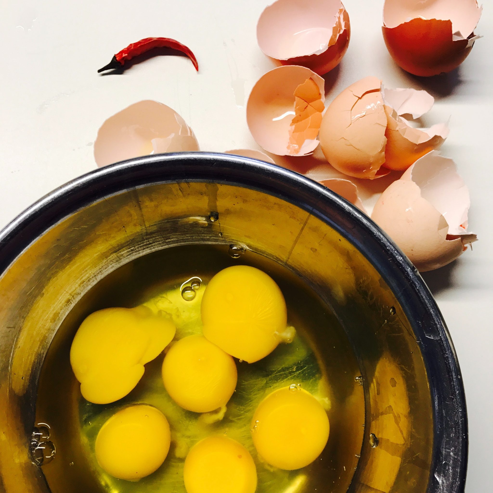 Detox Diet cracked eggs beside round blue bowl