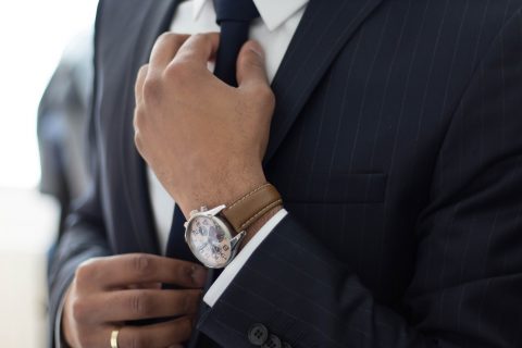 Dressing Well Dressing For The Workplace man wearing watch with black suit