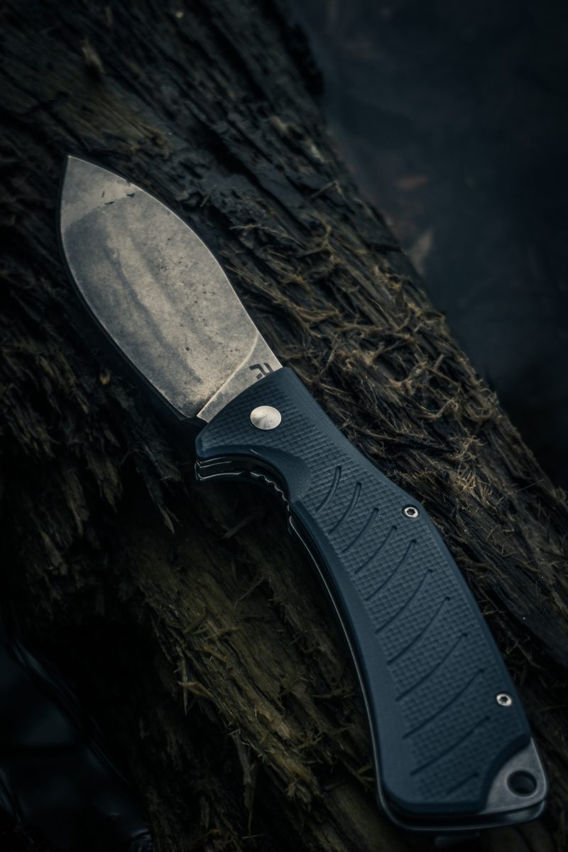 black and silver knife on brown wooden surface