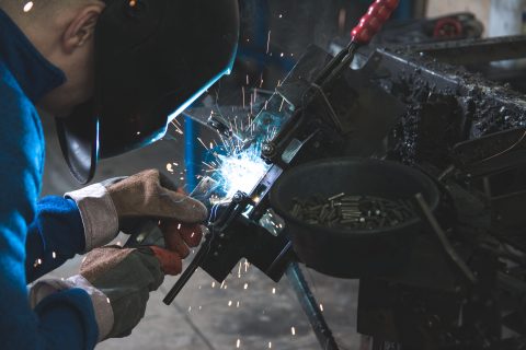 Injured At Work MIG Welding man welding a black metal