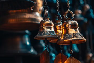 Musical Instruments gold bell hanging on brown wooden wall