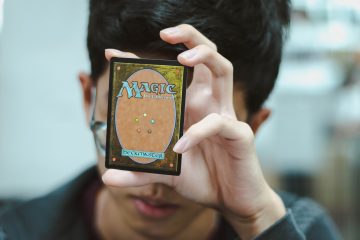 Classic Games boy holding Magic: The Gathering trading card