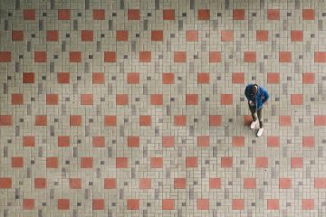 floor screeding man standing on brown and beige ground
