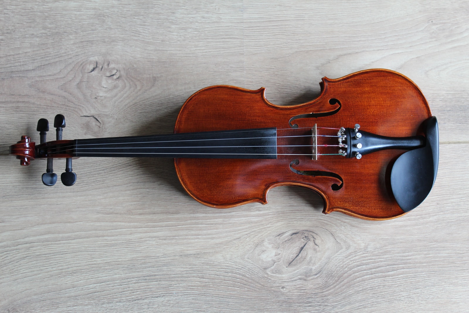 Viola brown violin on white textile