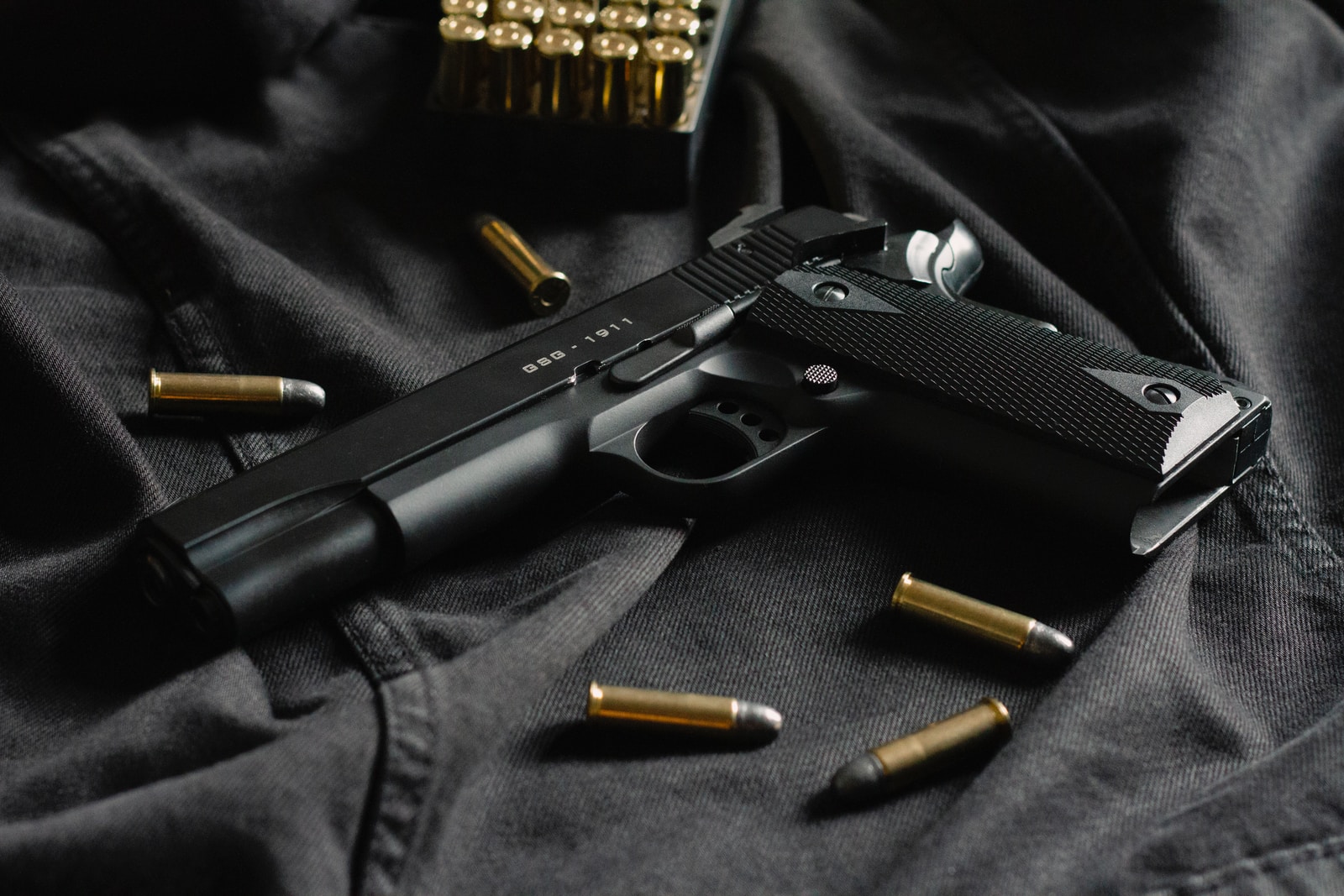 Firearms black semi automatic pistol on black textile