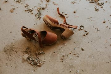 autumn pair of brown ankle-strap sandals on floor