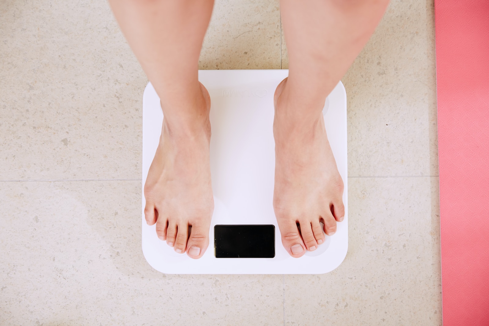 healthy eating habitsin Shape person standing on white digital bathroom scale