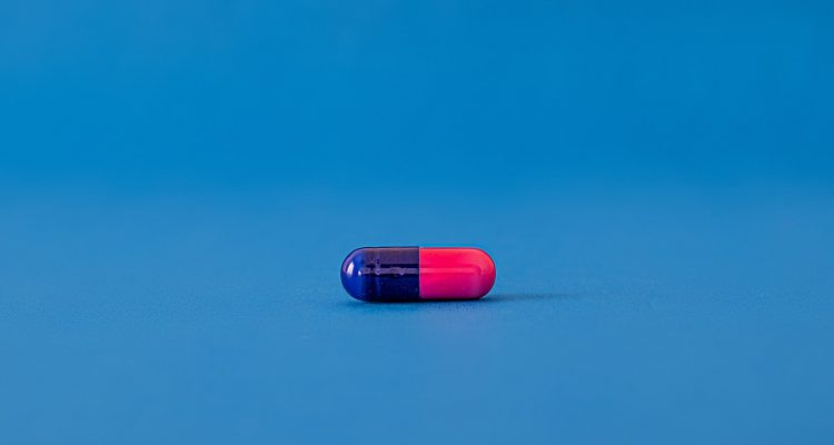 medication struggling with addiction Drug Addiction Autism Supplements red and blue pill on blue surface