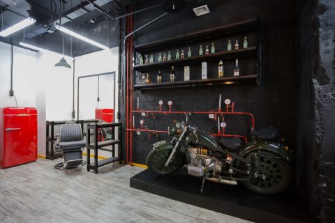 Instagram attract new customers Man Cave black motorcycle parked beside red truck