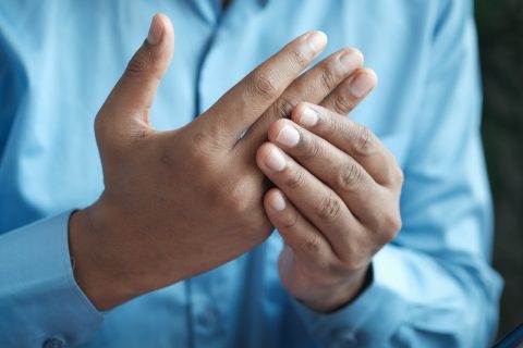 inflammation Collagen Arthritis person in blue shirt showing left hand