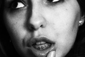 Coming out adult braces woman with silver nose piercing