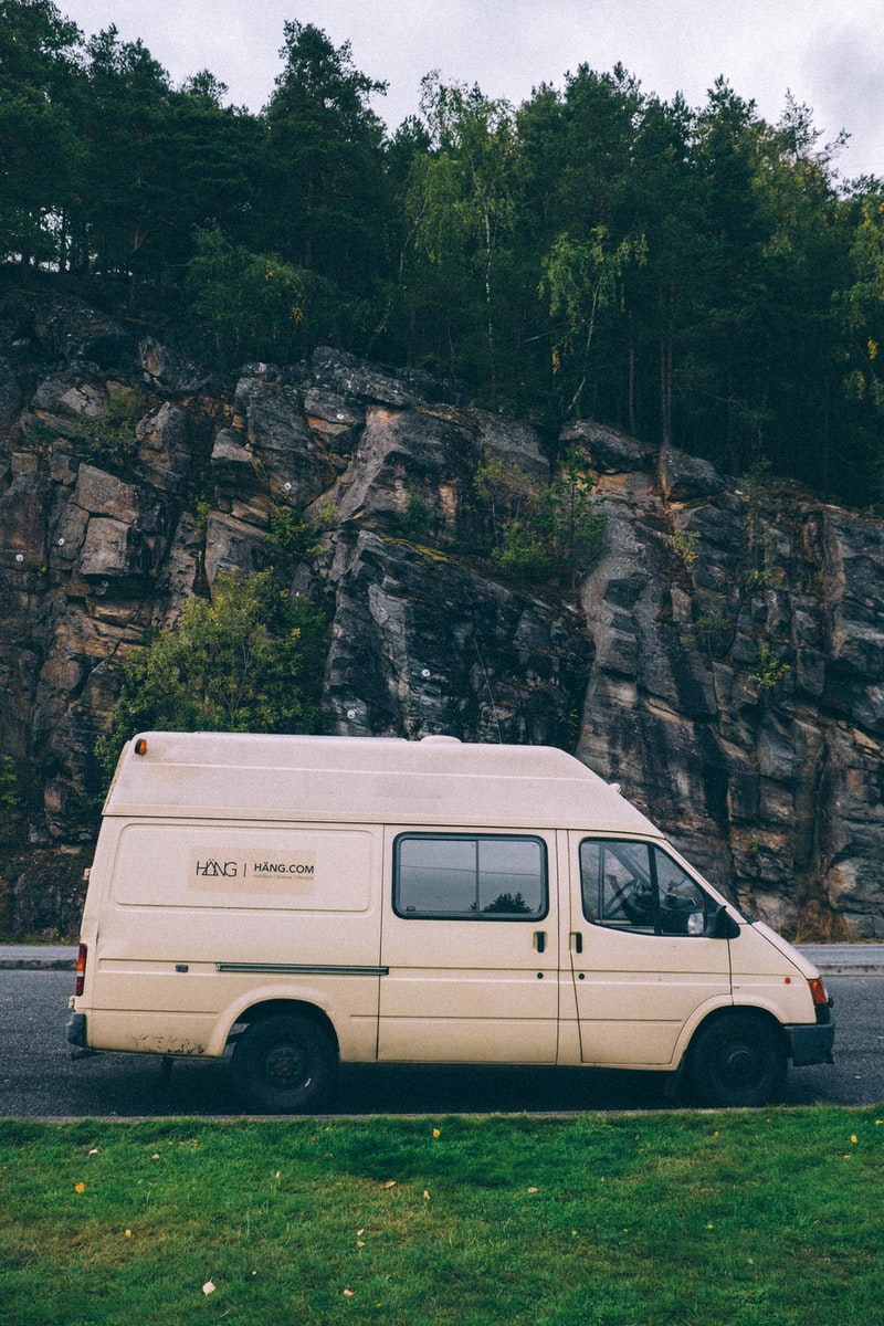 renting an rv white van parked near mountain