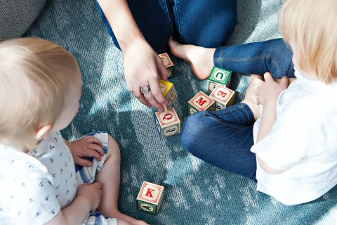 kids learning two toddler playing letter cubes