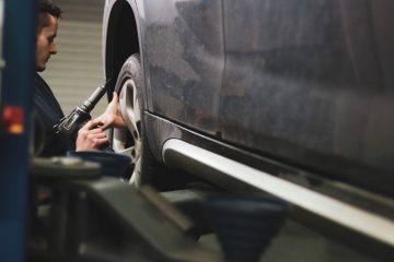 Service Centers person in black jacket driving car