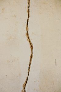 Addiction DIY House crack on white concrete surface