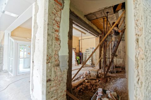 Home Renovation Renovating man climbing on ladder inside room