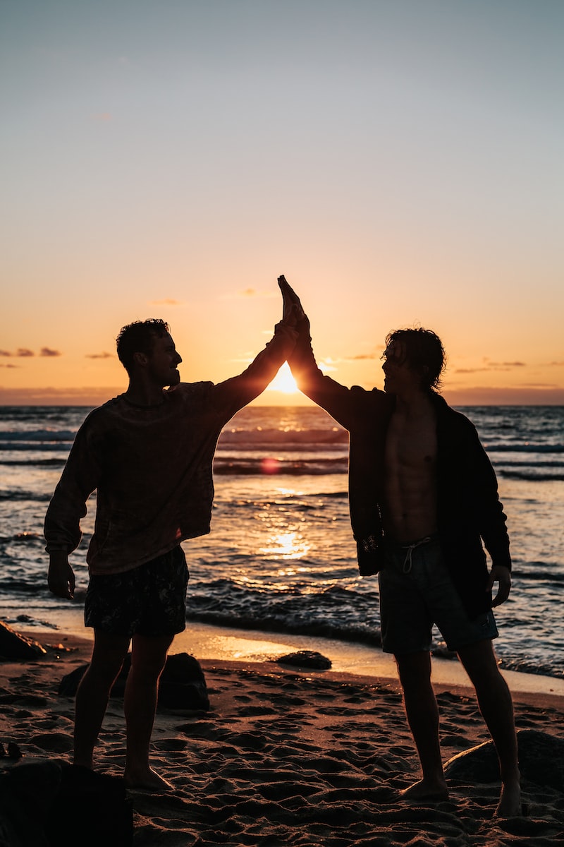 Group therapy career in human rights friends improve your life best mate two men clapping each other on shore