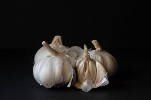 white garlic on black surface