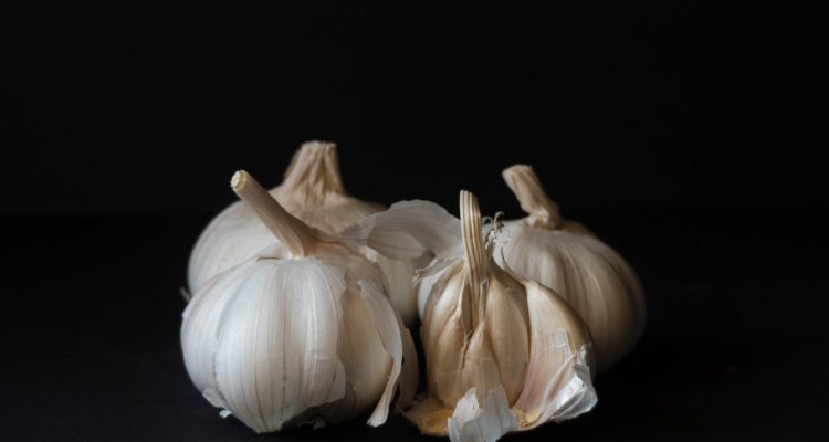 white garlic on black surface
