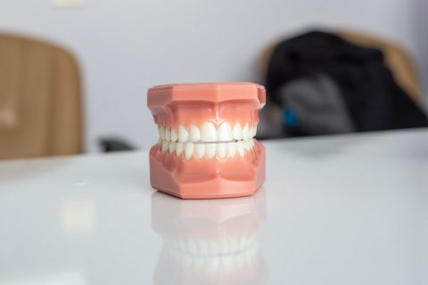 dental implants orange plastic container on white table