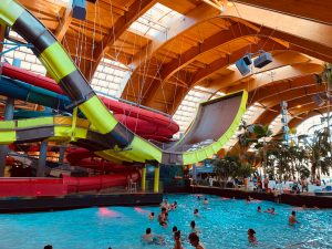 indoor water parks people swimming in pool during daytime