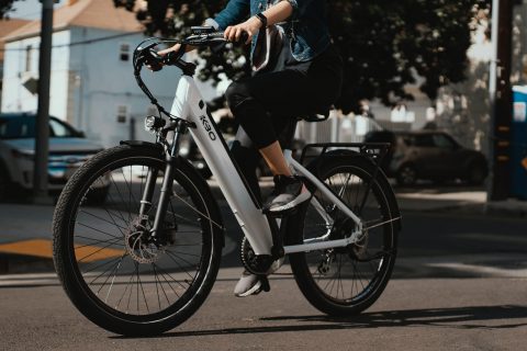 electric bike man in black jacket riding on white and black bicycle