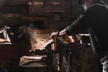 at work man sawing in room woodworking