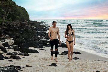 Thermage bikini line man and woman walking beside body of water