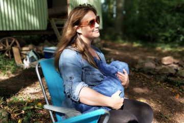 Nursing bras woman carrying baby while sitting on chair