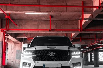 300 Series Landcruiser a white suv parked in a parking garage