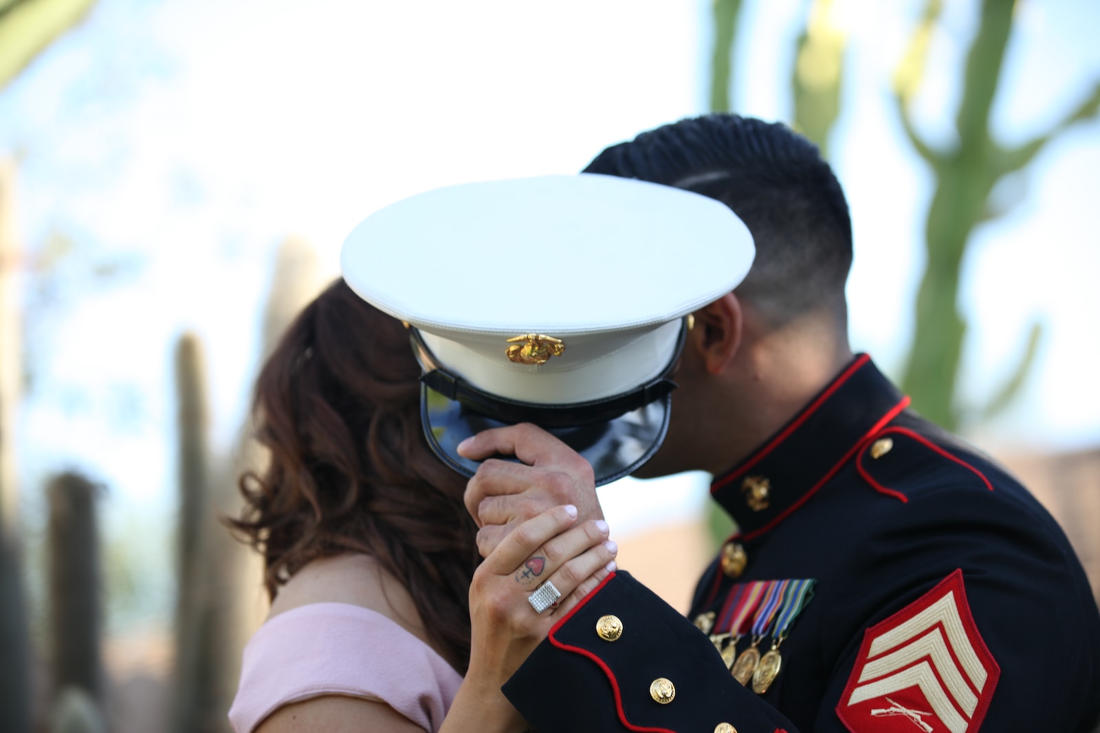 military ball man covering his face with cap