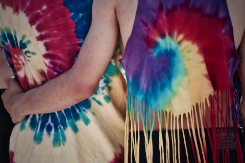 tie-dye person holding another person waist