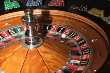 Roulette gamble casino stainless steel round table on brown wooden table