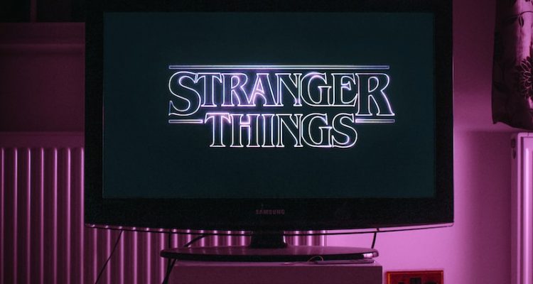 mounting black flat screen tv turned on displaying UNK