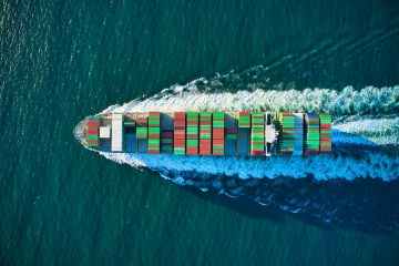Sustainable logistics maritime industry aerial view of blue and white boat on body of water during daytime