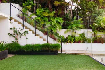 spring a white house with a green lawn and stairs