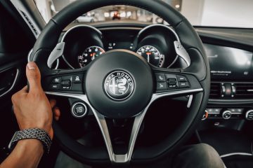 Alfa Romeo a person driving a car with a steering wheel