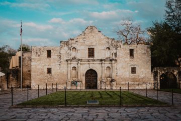 San Antonio brown concrete building near bare trees under blue sky during daytime