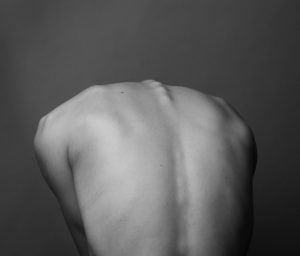 stressed back injuries grayscale photo of persons back