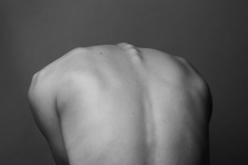 stressed back injuries grayscale photo of persons back