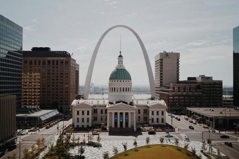 St. Louis white and green dome cathedral in between high-rise buildings during daytime