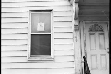 Foreclosure white wooden window frame on white wooden wall