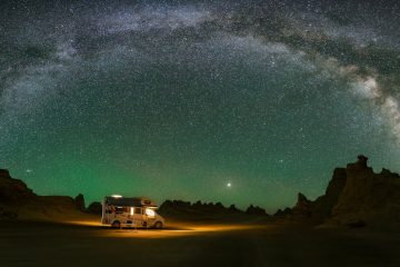 rv life a truck parked in the middle of a desert under a night sky filled with stars