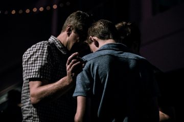 spiritual men touching each other's foreheads