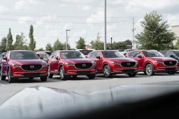 Mazda a row of cars parked in a parking lot