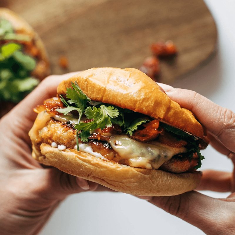 Gochujang chicken burger stacked with kimchi and toppings