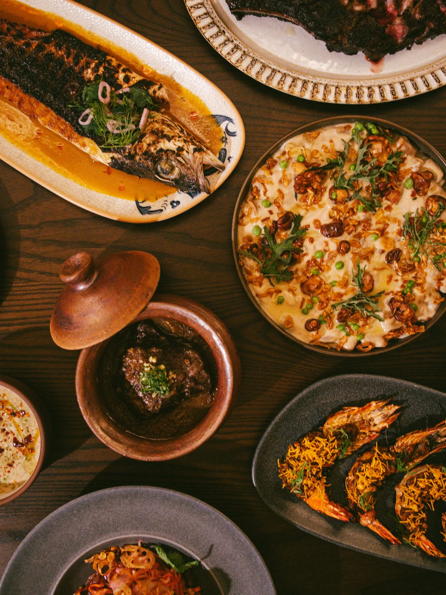 Array of shared dishes on a table at Muhajir in Chicago